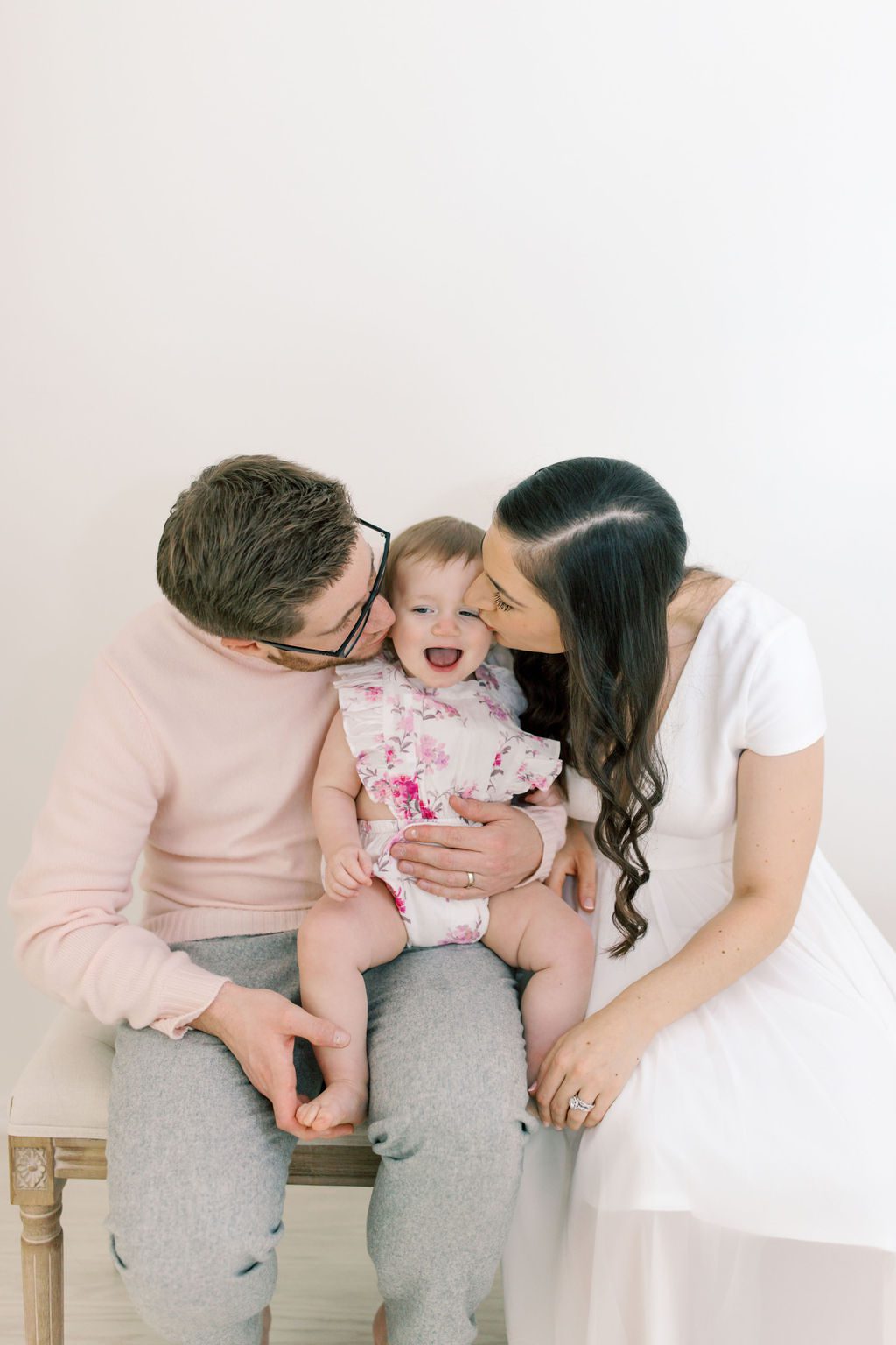 parents kissing daughter in family photography studios spokane wa