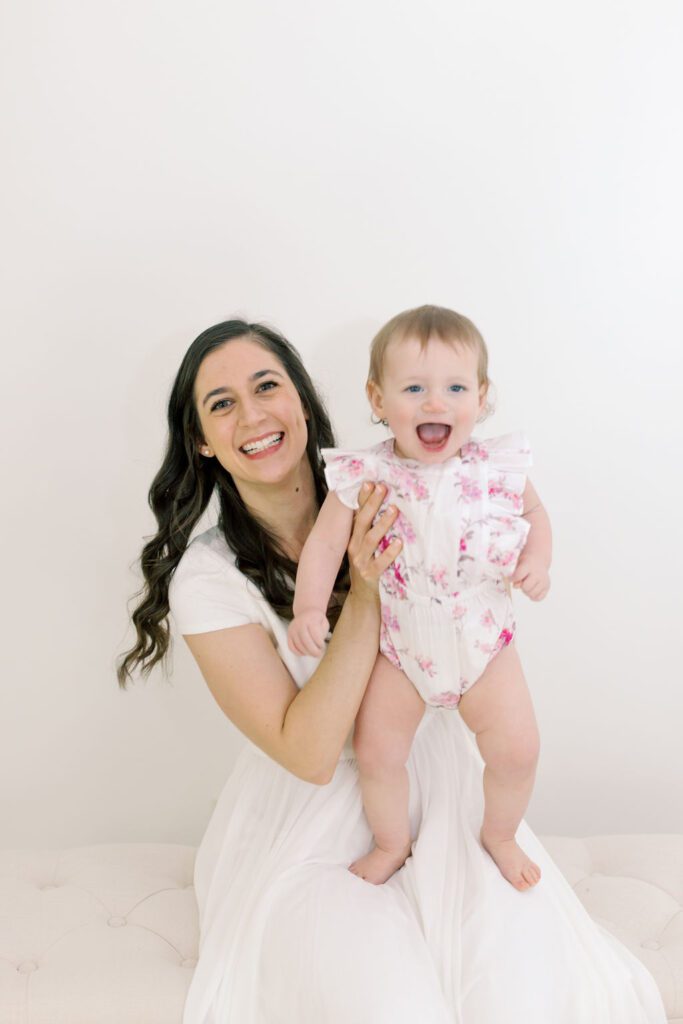 mother holding daughter in 1st birthday photoshoot