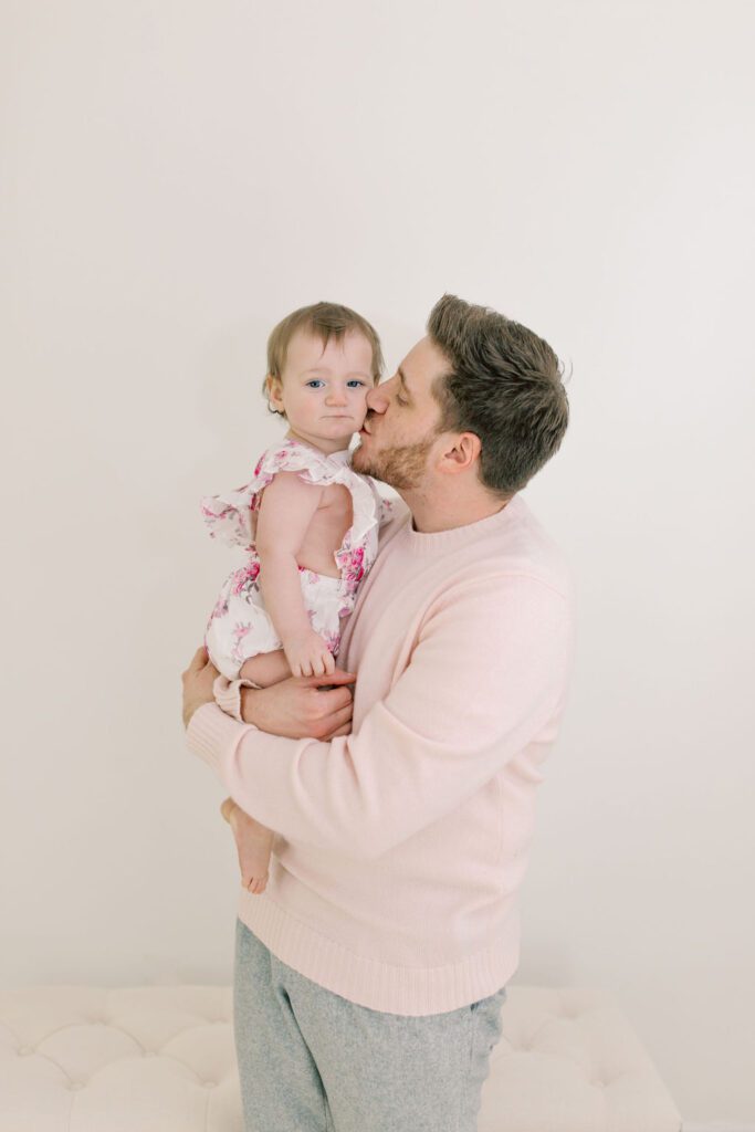 father kissing daughter in photography studios Spokane WA