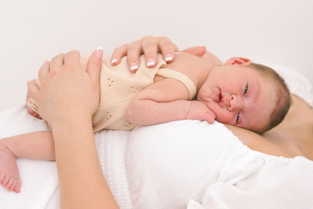 newborn laying on mom's chest in photo studio