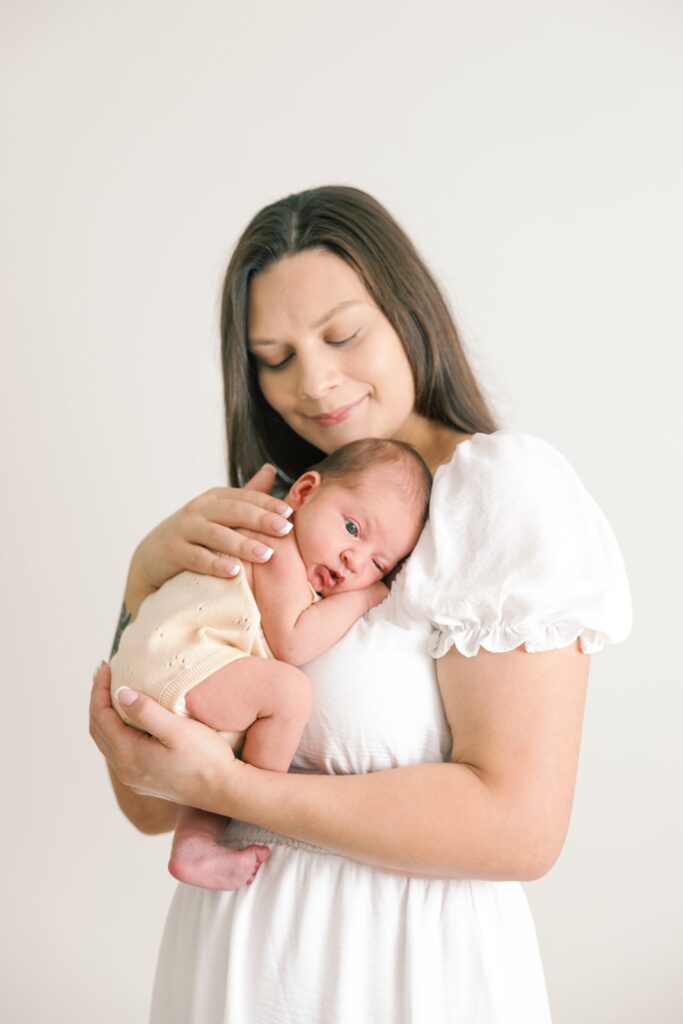 mom with newborn baby in a photography studio