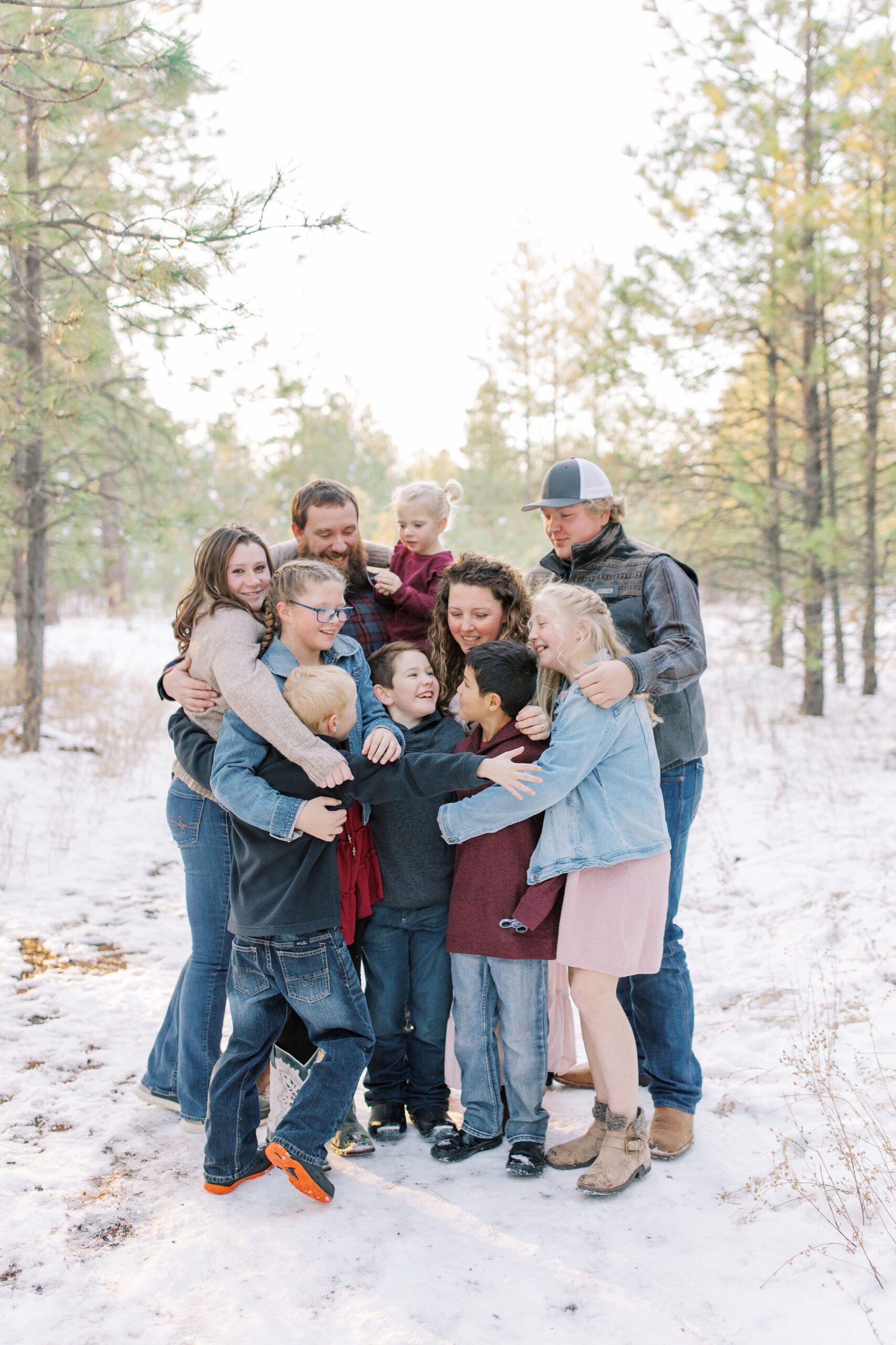 family hugging each other for winter photos in spokane